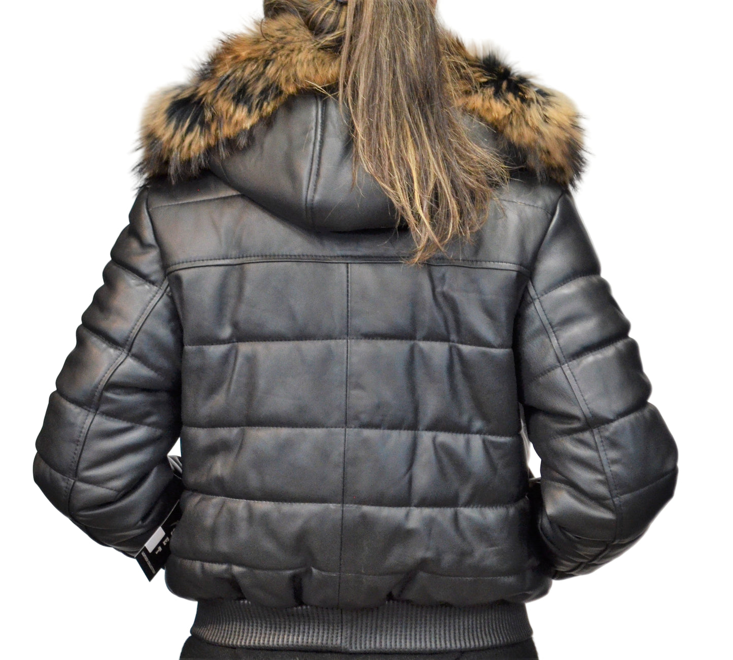 Back view of leather jacket on model with light puffer design and real fur hood, hands in pocket.